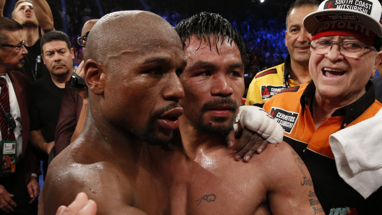 Floyd Mayweather Jr., left, hugs Manny Pacquiao after defeating him in 2015.