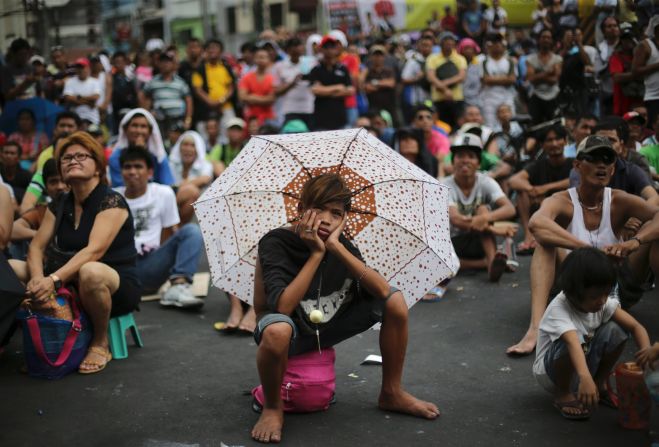 His face says it all. A boy watches a live satellite feed of the welterweight title fight between Filipino boxing hero Manny Pacquiao and Floyd Mayweather Jr.  The mayor of Manila set up free outdoor screenings for crowds in parks and sports stadiums on May 3.  Pacquiao lost.