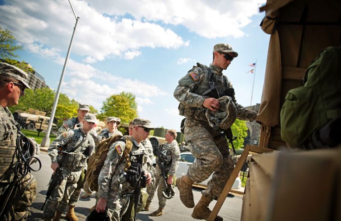 Members of the National Guard board a truck at an armory staging area on May 3 in Baltimore. After a night of relatively peaceful protests, <a href="index.php?page=&url=http%3A%2F%2Fwww.cnn.com%2F2015%2F05%2F03%2Fus%2Ffreddie-gray-baltimore-protests%2Findex.html">the city lifted a curfew</a>, the National Guard is preparing its exit and a mall that had been a flashpoint in the protests has been reopened. 