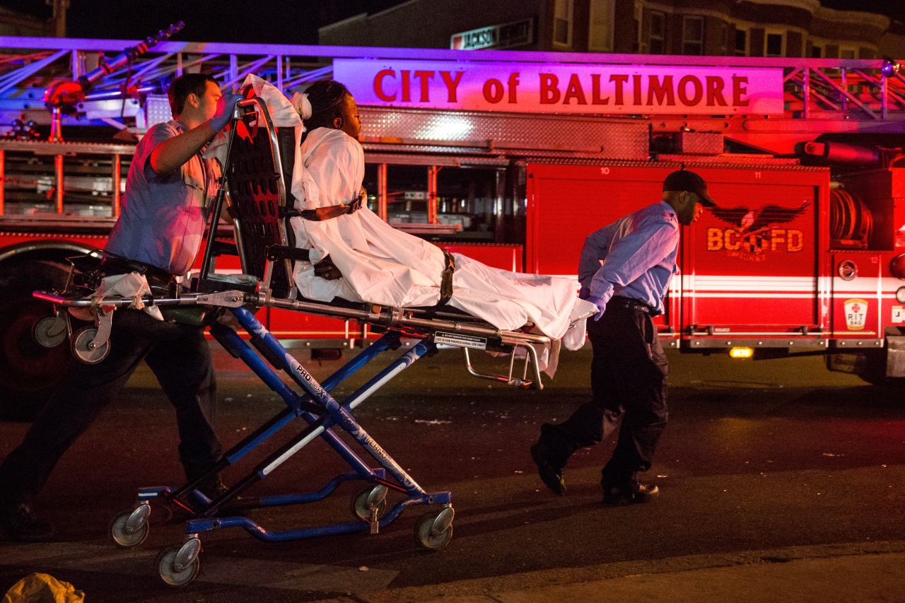Medics take a man away after police pepper-sprayed him on Saturday, May 2, in Baltimore's Sandtown neighborhood where Freddie Gray was arrested in April.