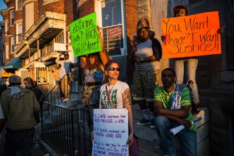 Protesters hold signs on May 2 in the Sandtown neighborhood.