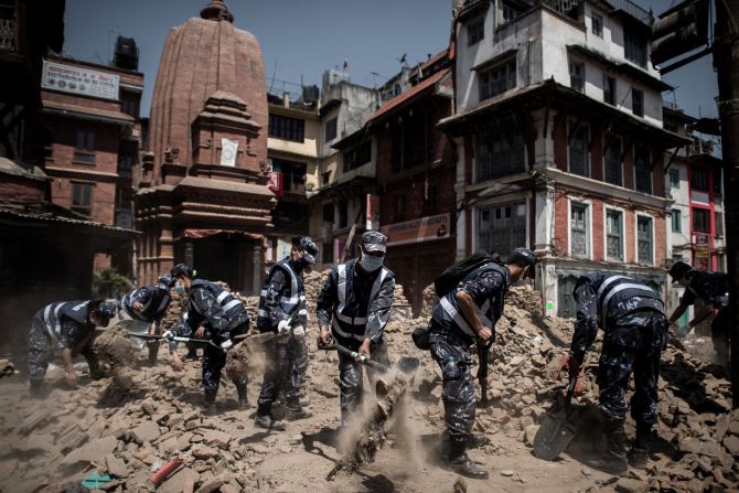 Nepalese police officers clear debris from Durbar Square in Kathmandu on Sunday, May 3. A magnitude-7.8 earthquake centered less than 50 miles from Kathmandu <a href="index.php?page=&url=http%3A%2F%2Fwww.cnn.com%2F2015%2F04%2F28%2Fasia%2Fnepal-earthquake%2Findex.html">rocked Nepal with devastating force</a> Saturday, April 25. The earthquake and its aftershocks have turned one of the world's most scenic regions into a panorama of devastation, killing and injuring thousands.