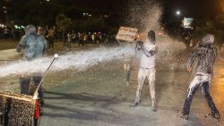 Israeli police use a water cannon against protestors Sunday evening.
