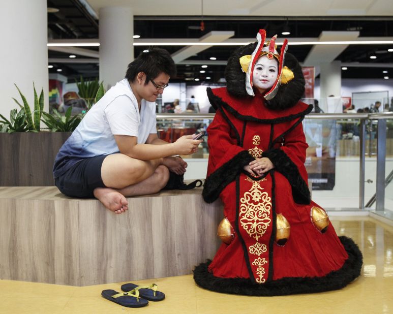 "Star Wars" fan Michelle Chee, right, dressed as Padme Amidala takes a rest during the "Star Wars Day" gathering in a mall downtown Kuala Lumpur, Malaysia, on May 2.