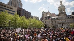 People attend a rally lead by faith leaders in front of Baltimore's city hall calling for justice in response to the death of Freddie Gray on Sunday May 3.