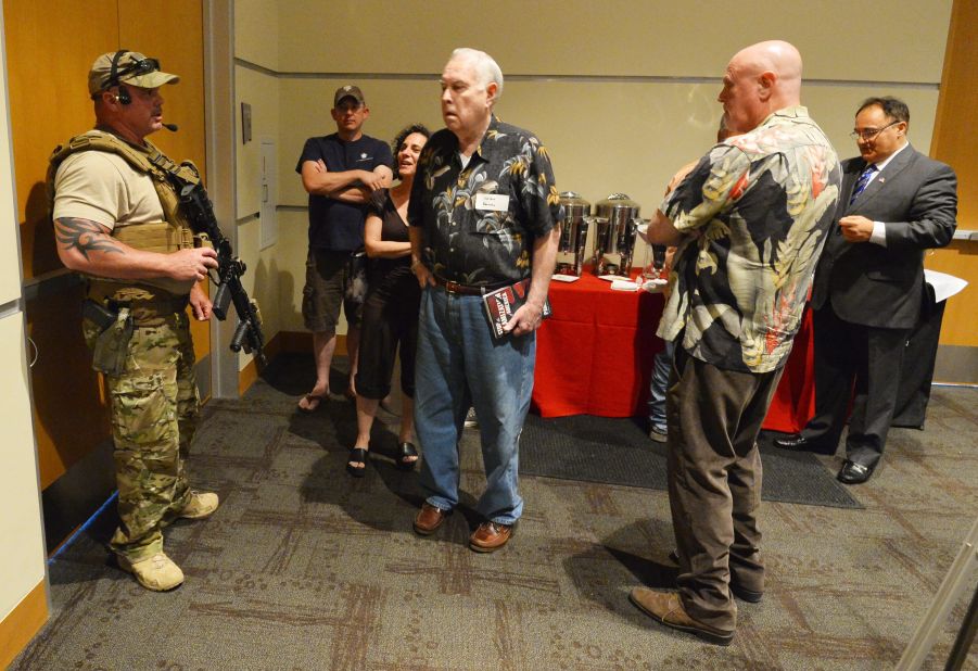 A member of the Garland Police Department keeps members of the audience inside the Curtis Culwell Center in Garland, Texas, after reports of shots fired outside. Two men were shot outside the event, called the Muhammad Art Exhibit and Cartoon Contest. The exhibit was sponsored by the American Freedom Defense Initiative.  