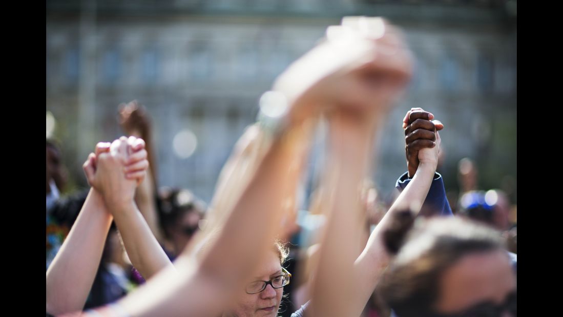 People hold hands during a rally at Baltimore City Hall on Sunday, May 3. The death of Freddie Gray, who died in police custody, sparked rioting in Baltimore and protests <a href="http://www.cnn.com/2015/04/30/us/gallery/freddie-gray-protests-across-us/index.html" target="_blank">across the country</a>.