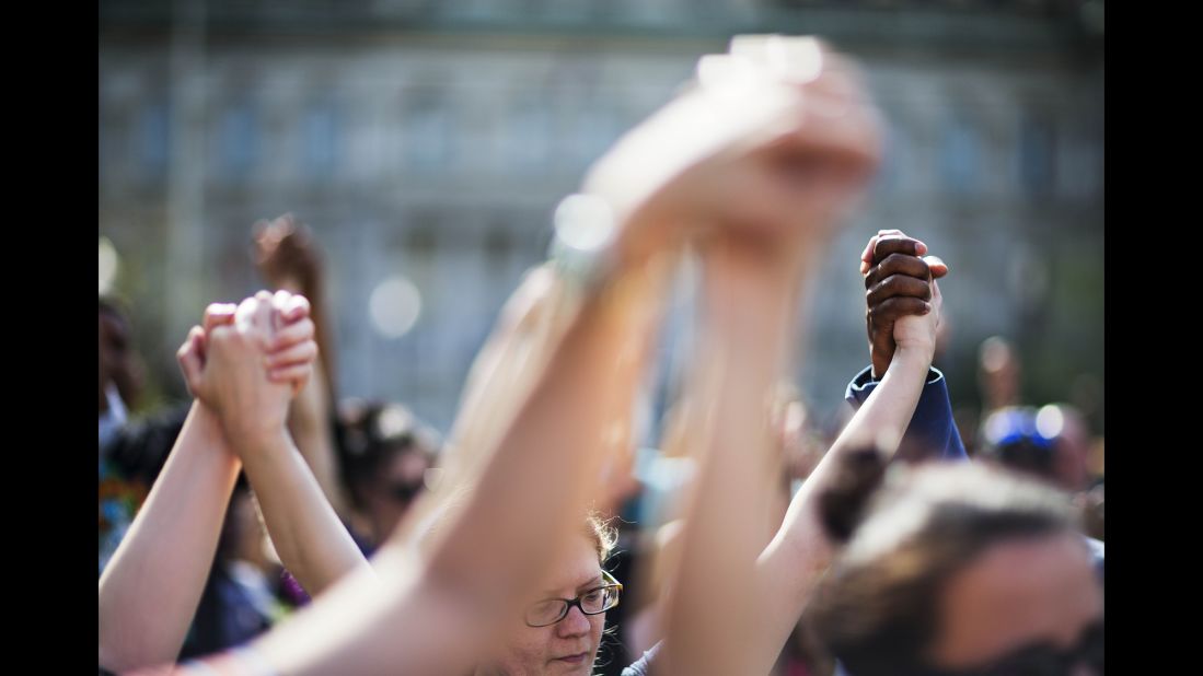 People hold hands during a rally at Baltimore City Hall on Sunday, May 3. The death of Freddie Gray, who died in police custody, sparked rioting in Baltimore and protests <a href="http://www.cnn.com/2015/04/30/us/gallery/freddie-gray-protests-across-us/index.html" target="_blank">across the country</a>. 