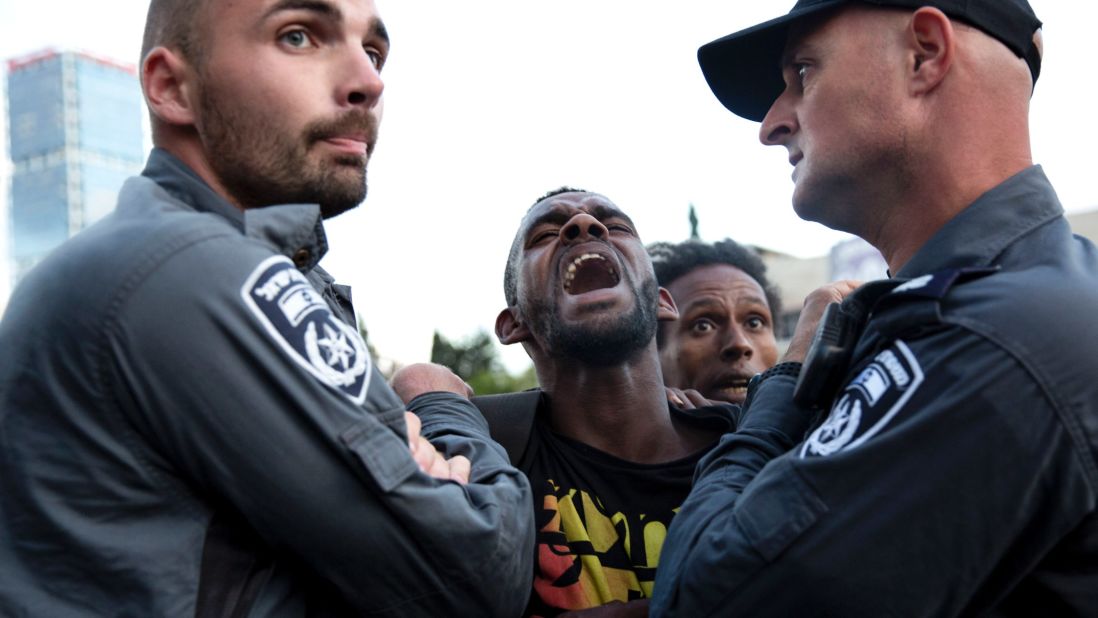 Israeli police officers detain a protester during a demonstration in Tel Aviv on May 3.