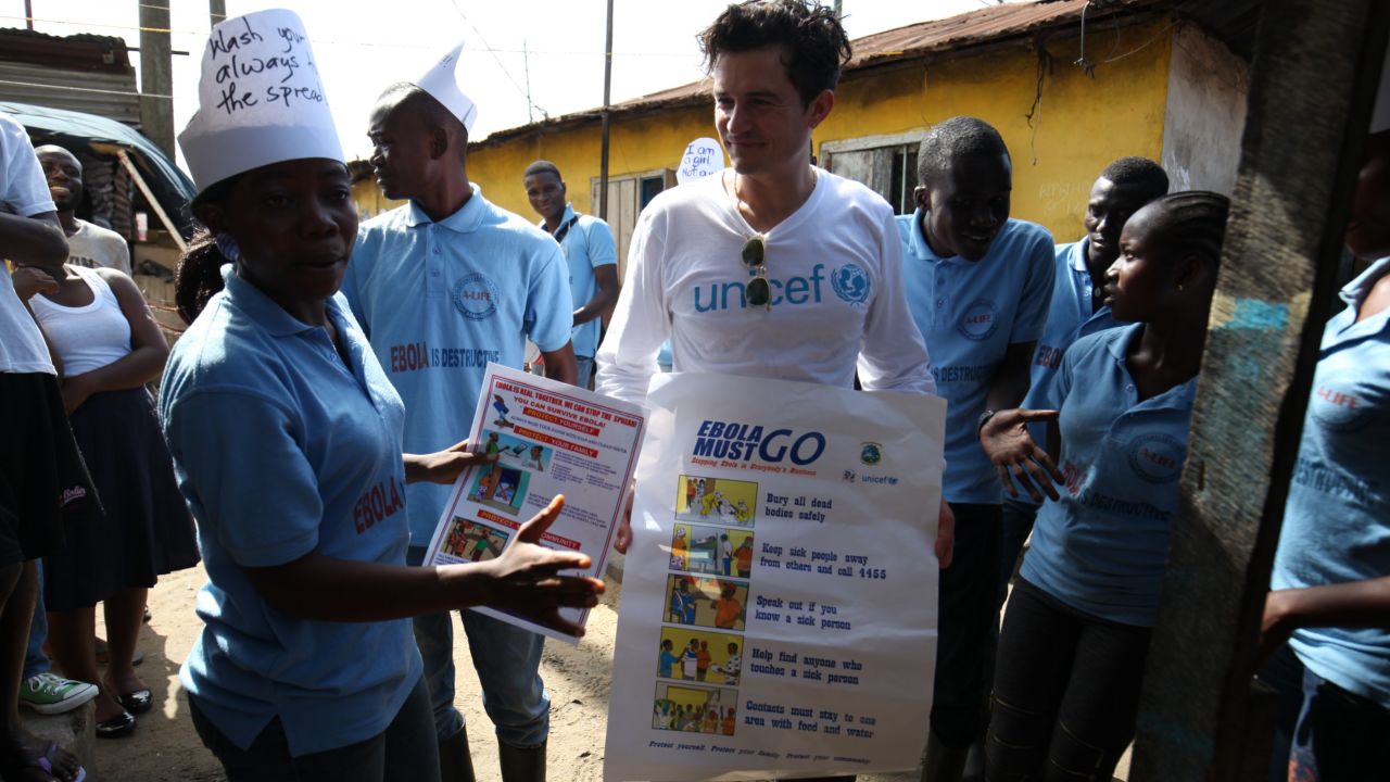 UNICEF Goodwill Ambassador Orlando Bloom carries posters about Ebola prevention, in Liberia. 