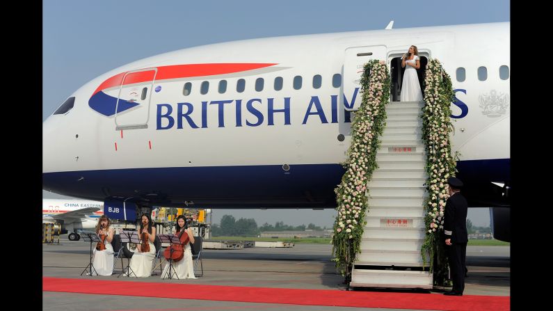 Mezzo-soprano Katherine Jenkins performs the Leonard Cohen classic "Hallelujah" on the flower-adorned steps of British Airways' new Boeing 787 Dreamliner to celebrate the inaugural flight from London Heathrow Airport to China's Chengdu International Airport on May 6, 2014.