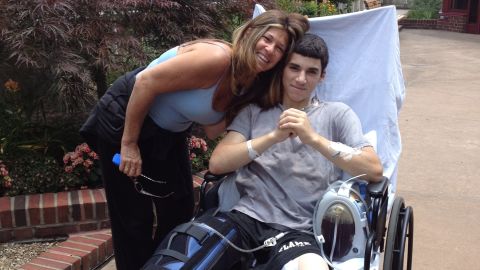 Max Gomez, with mom Doreen, recovers after his right leg was amputated following a motocross accident.
