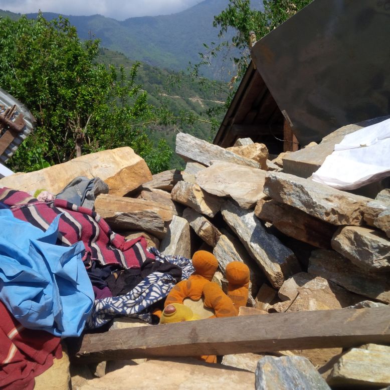 In Mandre village, a Winnie the Pooh plush toy lies in the rubble.