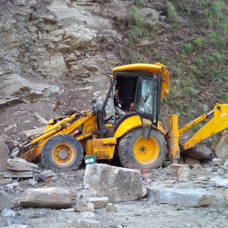 A digging machine lies crushed in the aftermath of the earthquake.
