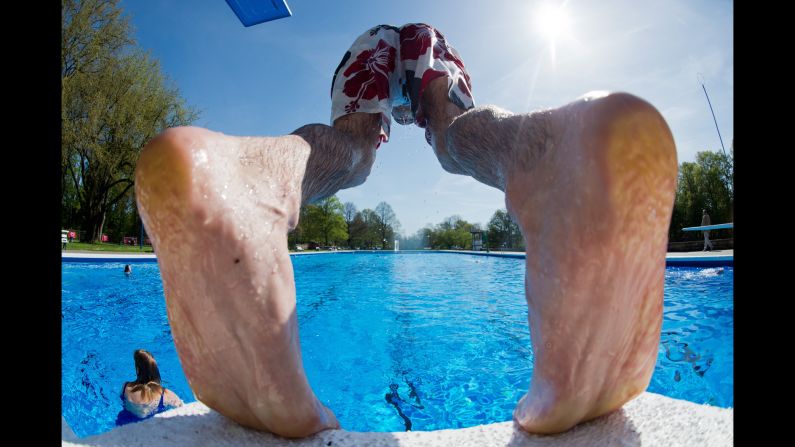 A man dives into the open-air swimming pool in Hanover, Germany, on Wednesday, April 29. <br />