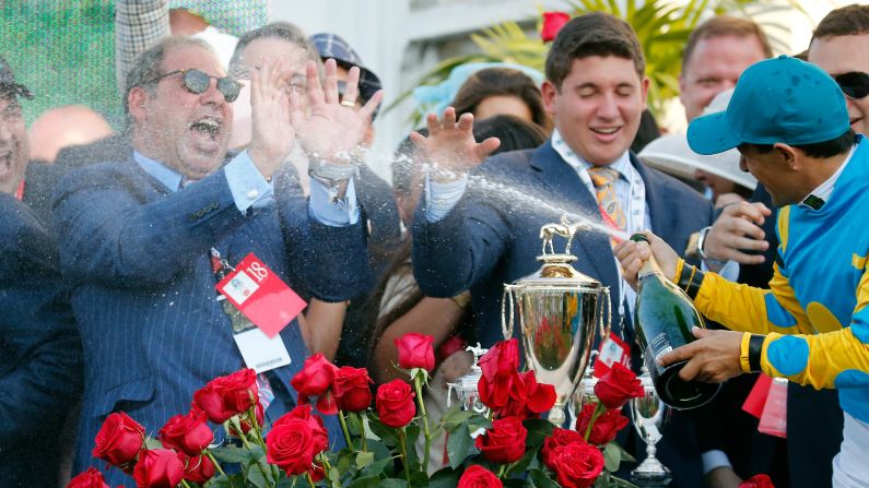 Jockey Victor Espinoza celebrates his third Kentucky Derby win by spraying Ahmed Zayat, owner of American Pharaoh, with champagne on Saturday, May 2, in Louisville, Kentucky. American Pharoah, the betting favorite all week, <a href="index.php?page=&url=http%3A%2F%2Fwww.cnn.com%2F2015%2F05%2F02%2Fsport%2Fkentucky-derby-american-pharoah%2Findex.html">won by one length</a>, outracing Firing Line to the finish line in front of a record crowd at Churchill Downs.