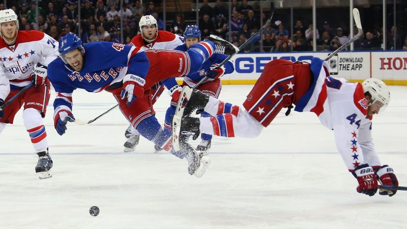 James Sheppard of the New York Rangers, left, is hit by Brooks Orpik of the Washington Capitals during the 2015 NHL Stanley Cup Playoffs on Saturday, May 2, in New York.