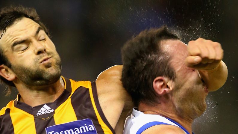 Jordan Lewis of the Hawks hits Todd Goldstein of the Kangaroos as he fights for possession of the ball during an Australian rules football match on Saturday, May 2, in Melbourne.