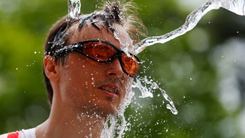 A competitor is splashed with water during the running leg of a 70.3-mile Ironman competition in Aix-en-Provence, France, on Sunday, May 3.