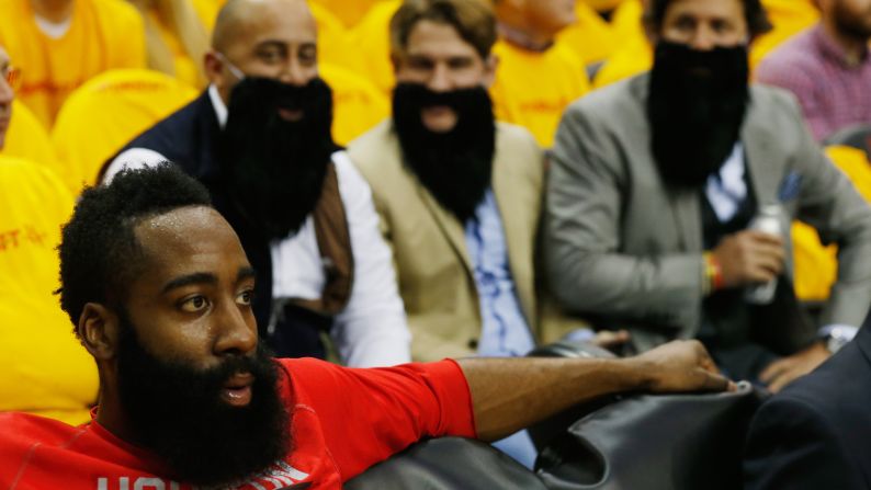 Bearded Houston Rockets fans wait behind Rockets player James Harden before the start of the game against the Dallas Mavericks in Houston on Tuesday, April 28, during the quarterfinals of the 2015 NBA Playoffs.