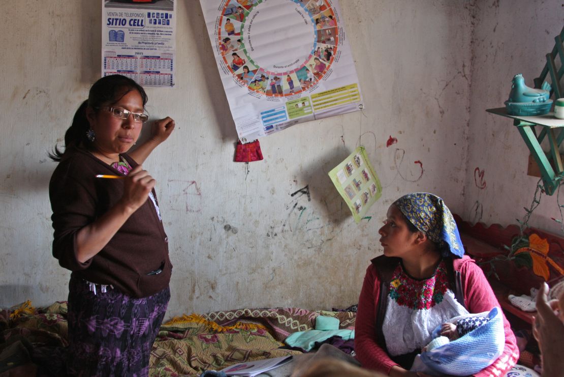 Health worker Aura Fuentes uses an illustrated wheel to help Mauricia keep track of her progress.