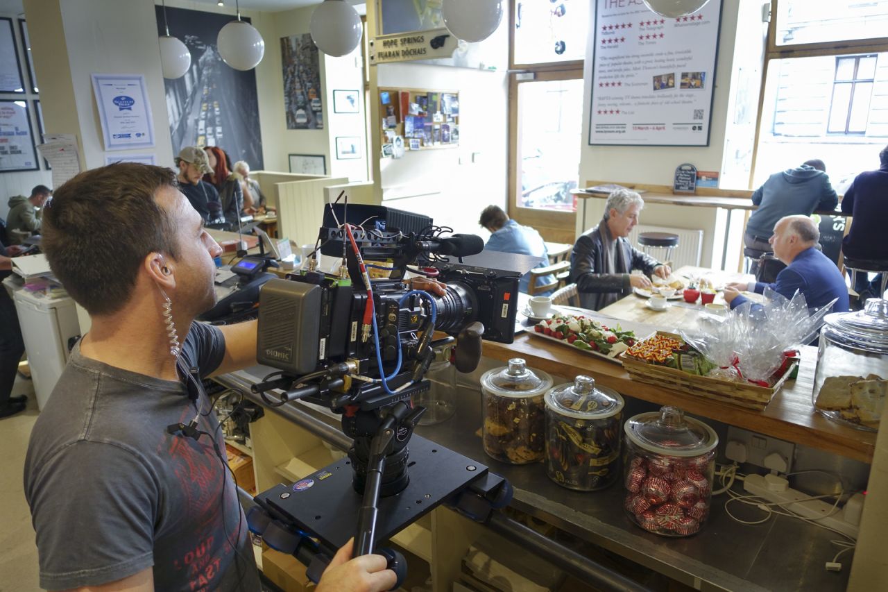 Director Nick Brigden shoots a scene at The Wee Guy's Cafe in Glasgow.