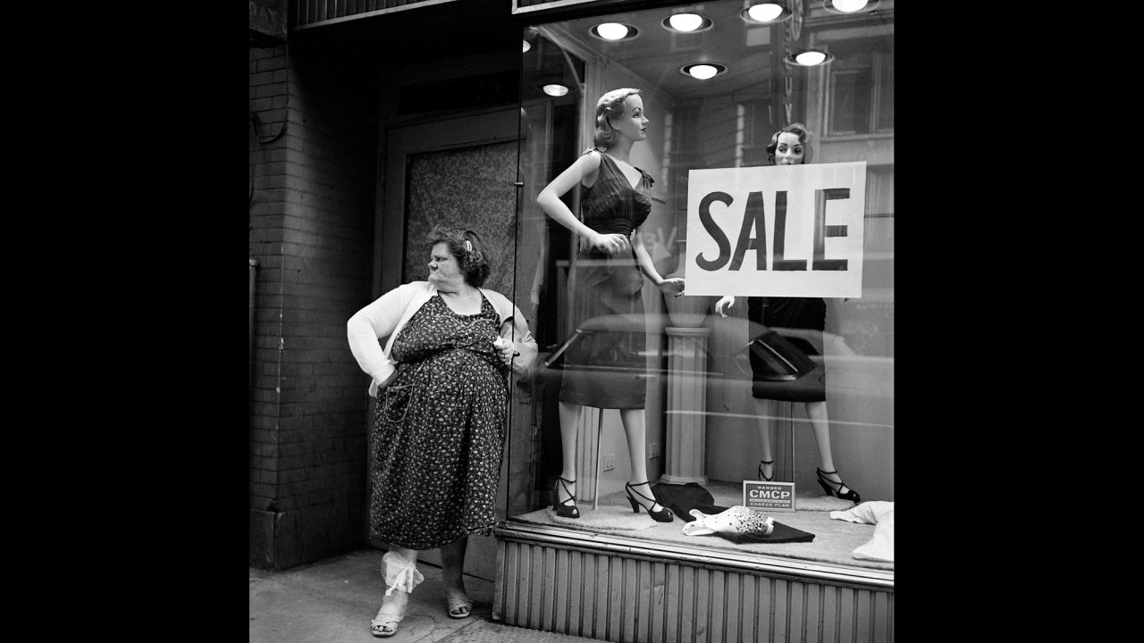 A woman stands in front of a New York store window in 1959. DiGirolamo and his wife traveled together back and forth from New York to Italy, where he was born. He later was a  physician and scientist at Emory University in Atlanta for decades.