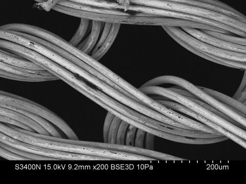 Conductive yarns -- most commonly made with silver -- are woven into fabrics to act as sensors that detect electrical signals, acting as electrocardiograms (ECGs). The data is transmitted wirelessly to a detection device, such as a smartphone. Pictured, the silver-coated X-STATIC fibers used by CircuiteX clothing as seen through an electron microscope.