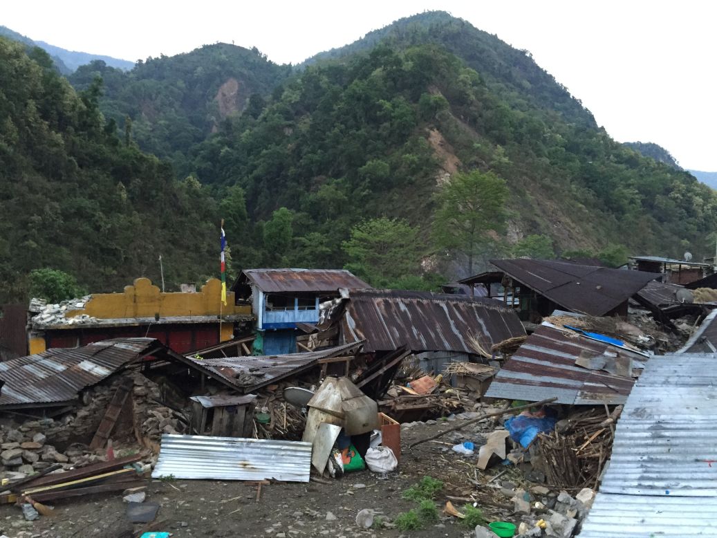 As the CNN team treks through the mountains, they come across small villages that are completely destroyed.