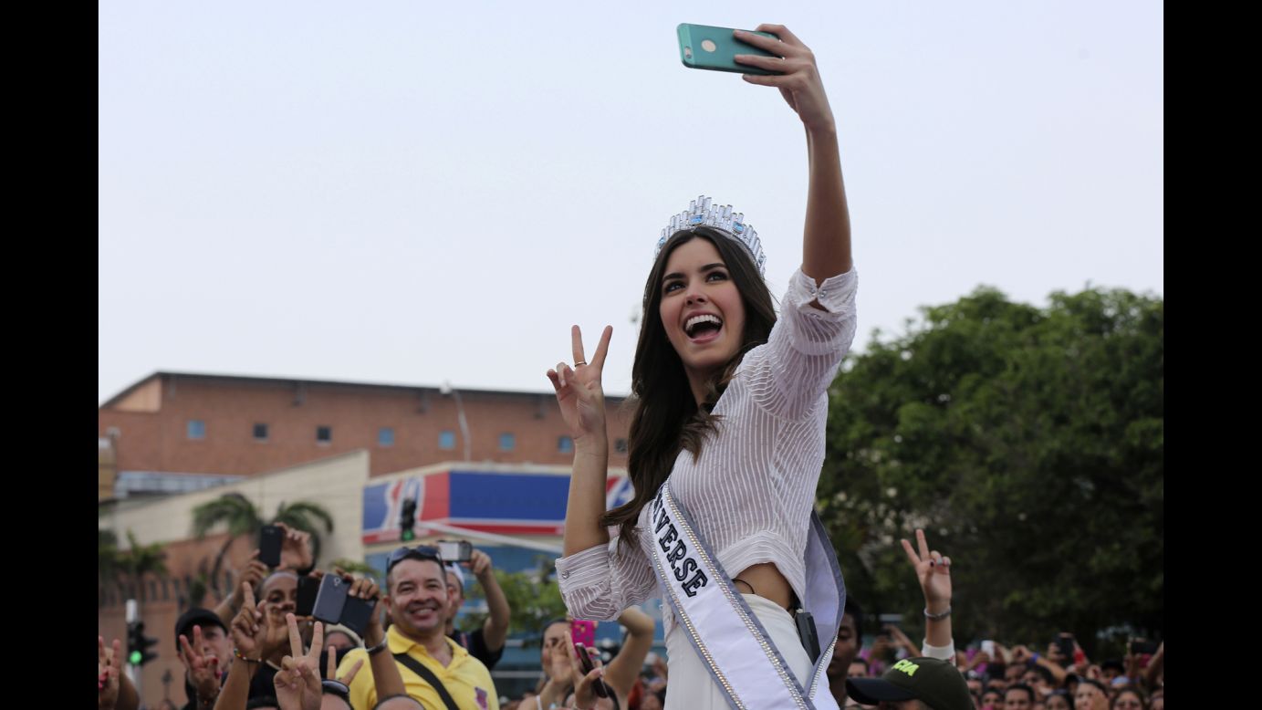 Colombian Miss Universe Paulina Vega Dieppa takes a selfie with a fan's phone during a welcoming event on Friday, on May 1, in her hometown Barranquilla.