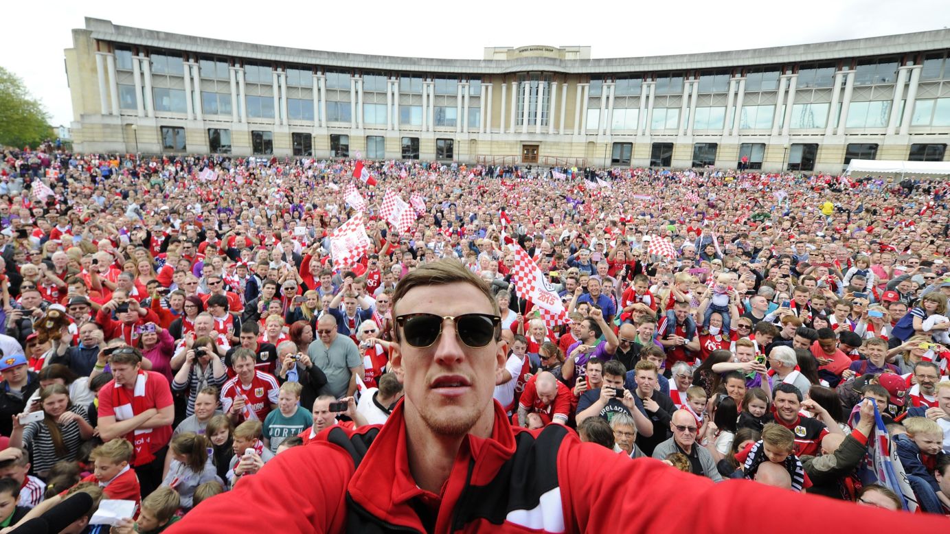 Bristol City soccer player Aden Flint takes a selfie in front of fans gathered at the amphitheater in Bristol on Monday, May 4.