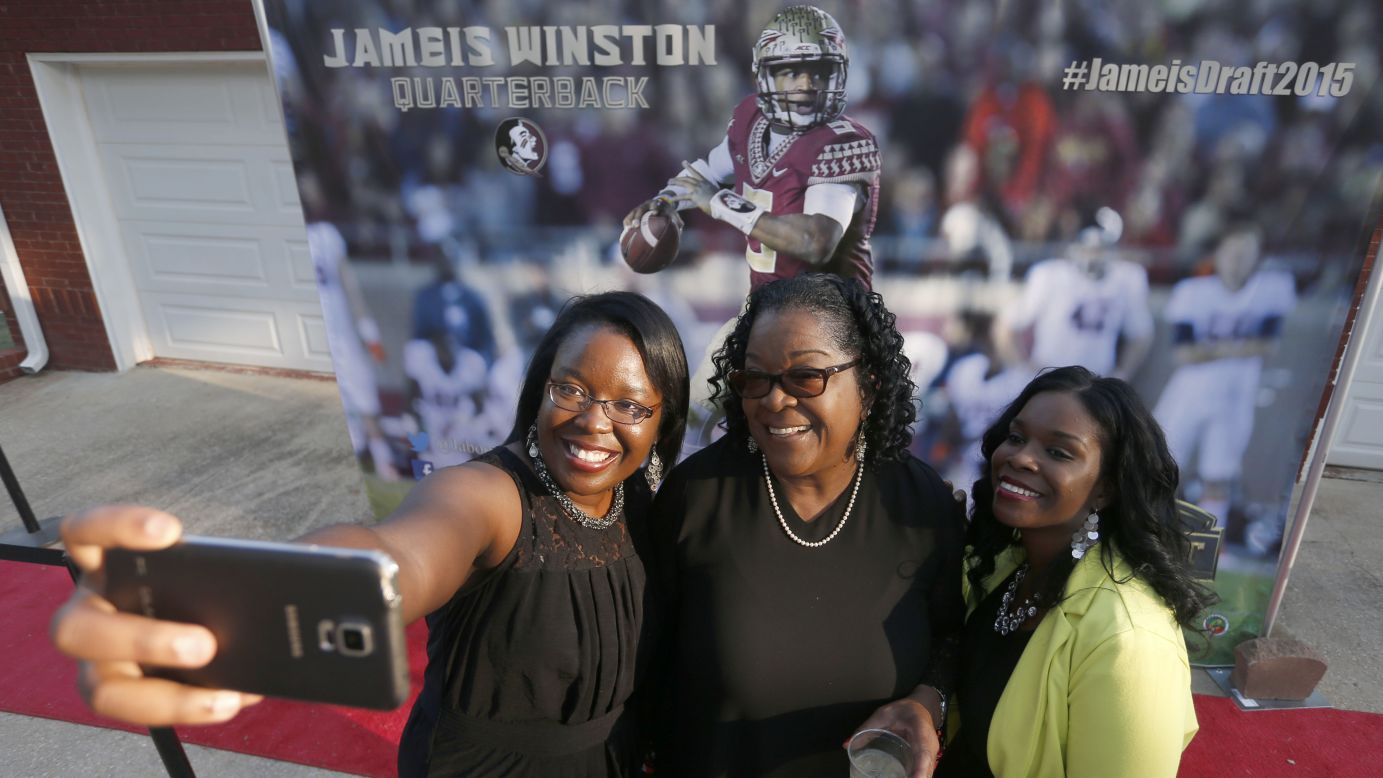 Three women pose for a selfie in Bessemer, Alabama, in front of a Jameis Winston mural at an NFL draft celebration on Thursday, April 30. The quarterback was drafted by the Tampa Bay Buccaneers from Florida State University.