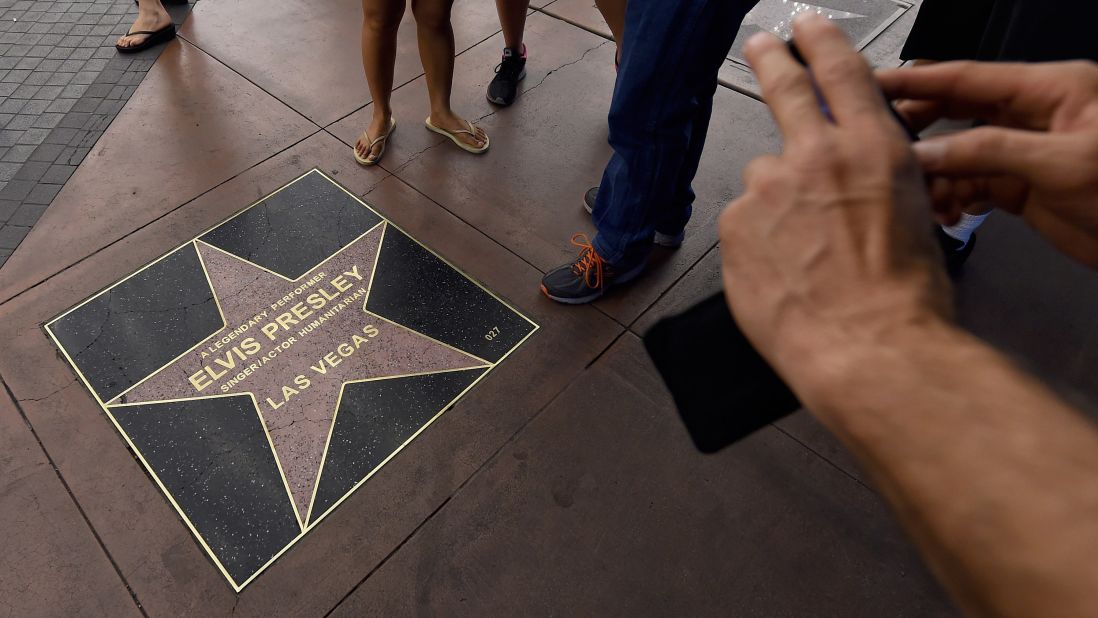 Visitors take photos of Elvis Presley's star from the Las Vegas Walk of Stars at the Riviera on Sunday, May 3, its last day of operation.