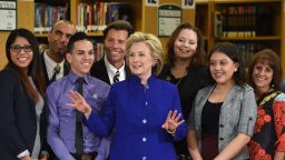 Democratic presidential candidate and former U.S. Secretary of State Hillary Clinton (C) poses with students and faculty after speaking at Rancho High School on May 5, 2015 in Las Vegas, Nevada. Clinton said that any immigration reform would need to include a path to 'full and equal citizenship.'