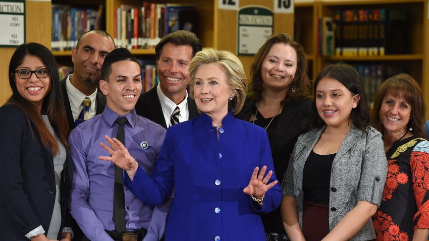 Democratic presidential candidate and former U.S. Secretary of State Hillary Clinton (C) poses with students and faculty after speaking at Rancho High School on May 5, 2015 in Las Vegas, Nevada. Clinton said that any immigration reform would need to include a path to 'full and equal citizenship.'