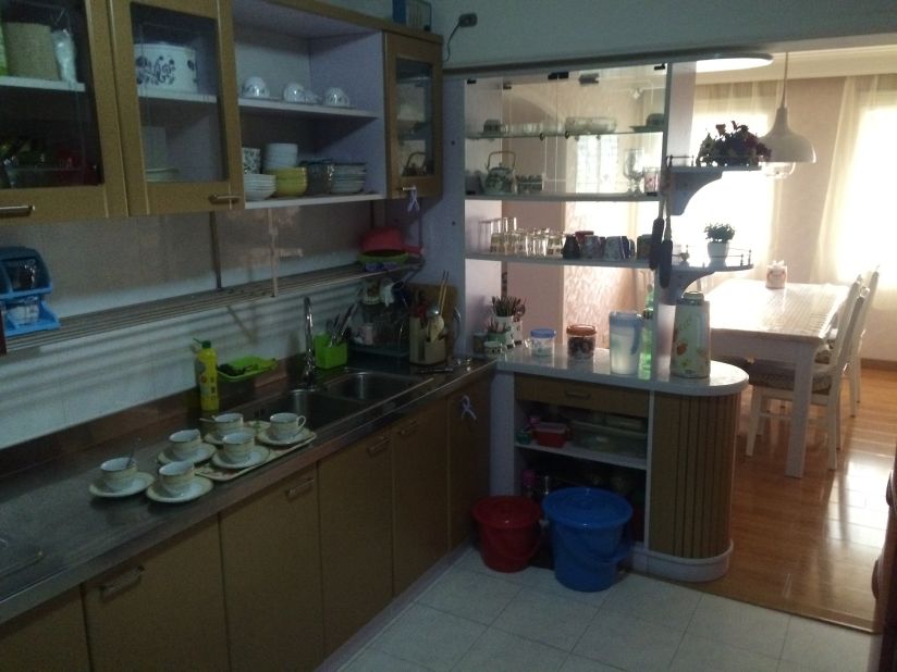 The kitchen features a double sink and brushed metal counter tops. 