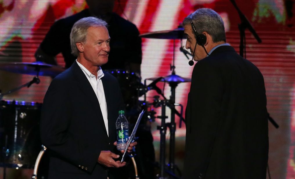 Chafee, left, then governor of Rhode Island, stands on stage with stage manager David Cove during Day One of the Democratic National Convention in Charlotte, North Carolina, on September 4, 2012.