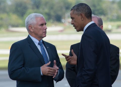Pence and President Obama chat at Evansville Regional Airport in Indiana on Obama's arrival on October 3, 2014, to discuss investments in American manufacturing.