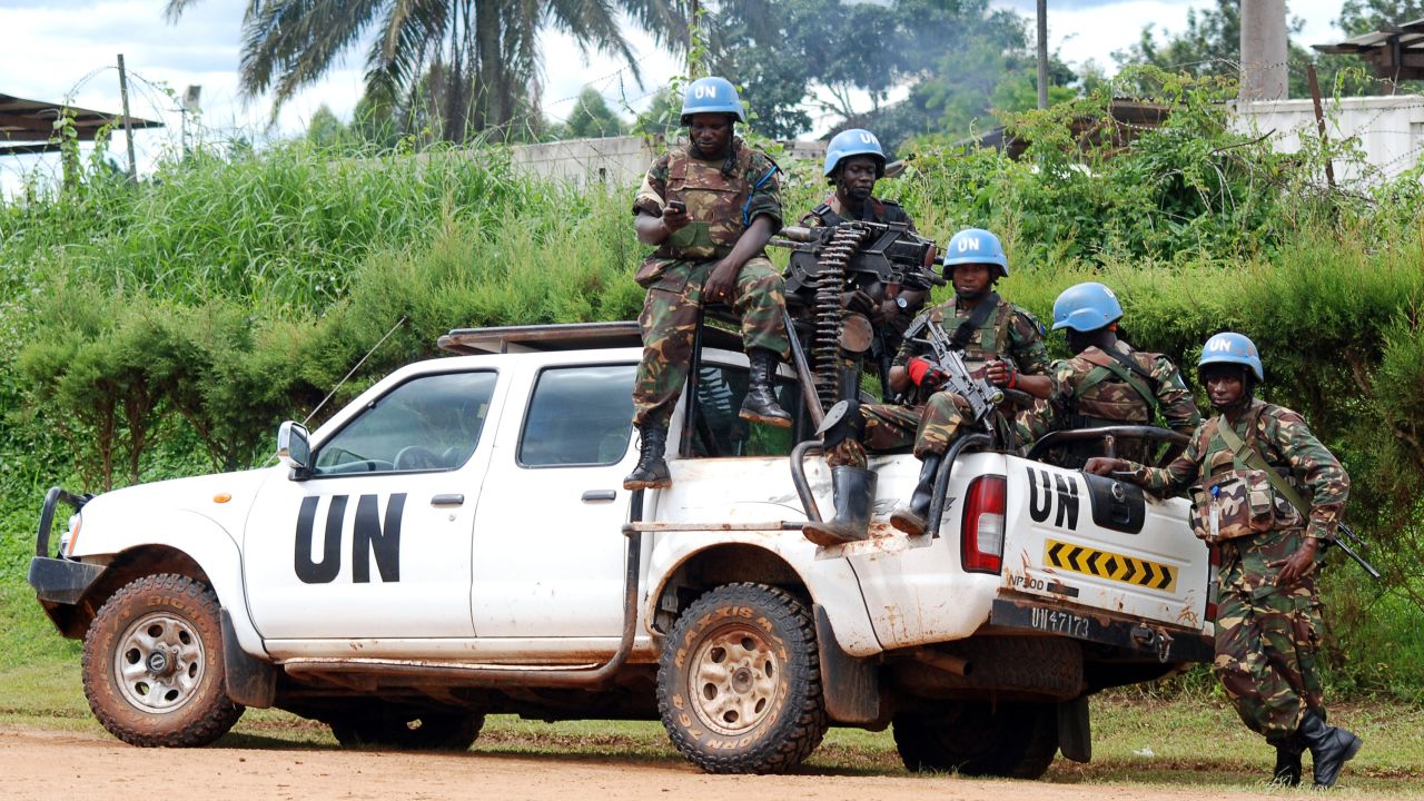 File: Blue helmet members of the United Nations Organization Stabilization Mission in the Democratic Republic of Congo sit on the back of a UN pickup truck on October 2014 in Beni.