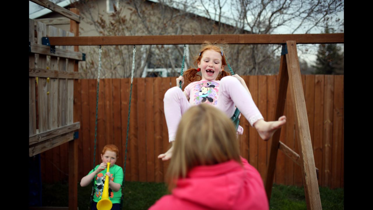 Emily laughs as Cheryl plays with her in the backyard of their home in Manitoba. She is her brother and mother's biggest cheerleader. For weeks after Cheryl's diagnosis, she would make her mother cards as soon as she walked in the door from school.