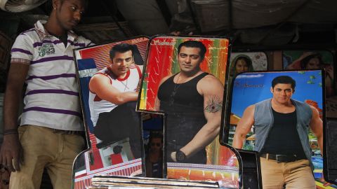 An Indian man displays photographs of Bollywood actor Salman Khan, custom made for decorating the interiors of auto-rickshaws in Ahmadabad, India, in May 2015. 