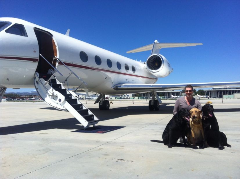 Celebrity Stylist Chaz Dean prepares to board a Gulfstream G-IV with his Labradors.
