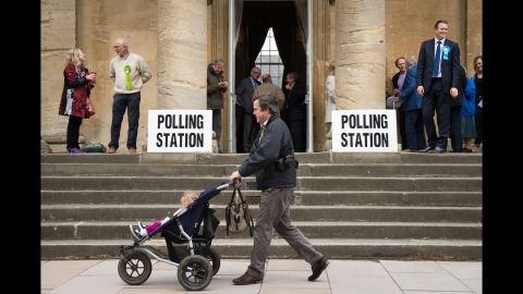People arrive at a polling station in Chipping Norton, England, to cast their votes.