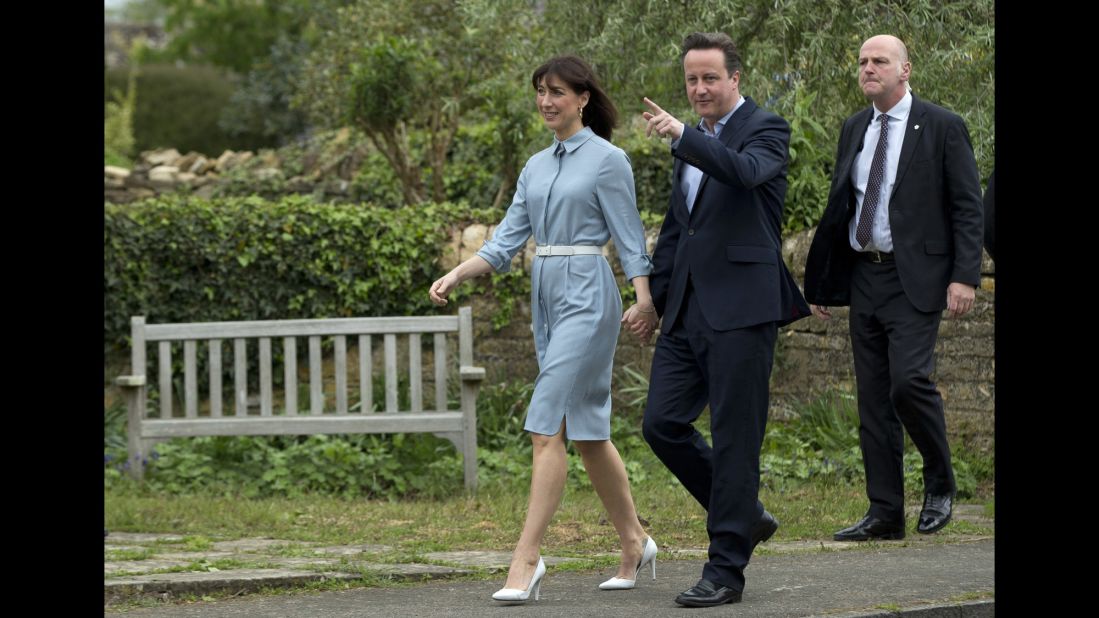 British Prime Minister David Cameron, leader of the Conservative Party, and his wife, Samantha, arrive at a polling station in Spelsbury, Oxfordshire, England.