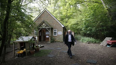 A member of the public leaves a polling station in Mattingley, England.