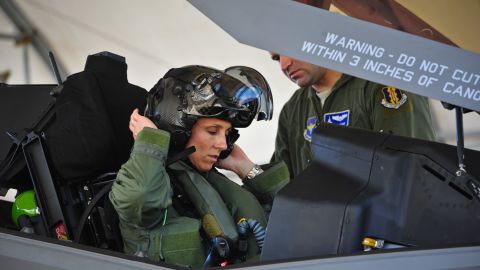 Lt. Col. Christine Mau, 33rd Operations Group deputy commander, puts on her helmet before taking her first flight in the F-35A on Eglin Air Force Base, Fla., May 5, 2015. Mau, who previously flew F-15E Strike Eagles, made history as the first female F-35 pilot in the program. (U.S. Air Force photo/Staff Sgt. Marleah Robertson)