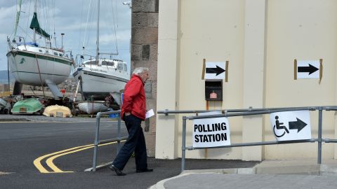 A man walks to the Groomsport boat house in Belfast, Northern Ireland, to cast his vote on Thursday, May 7.
