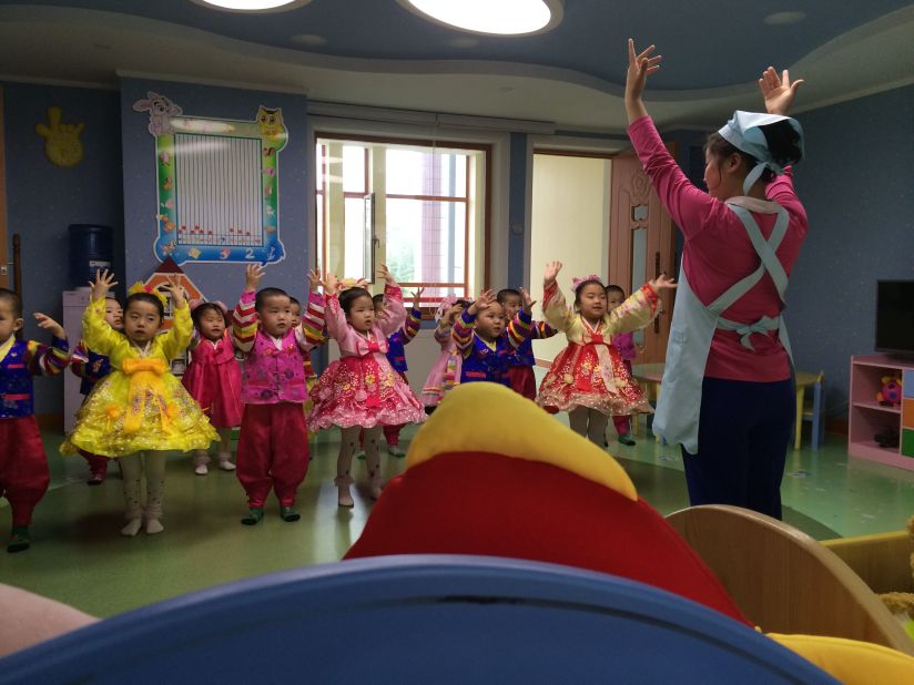 Young children in a newly constructed Pyongyang orphanage practice a musical performance.