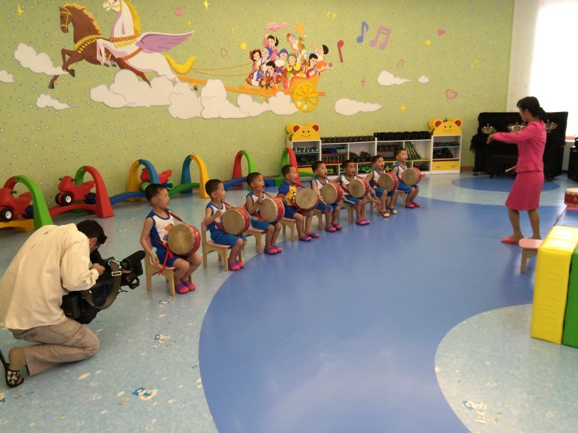 Young boys practice a drum routine that they will perform during International Children's Day.