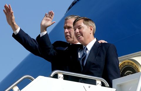 U.S. President George W. Bush, left, stands with Graham on the steps of Air Force One at the airport in Greenville, South Carolina, in March 2002.